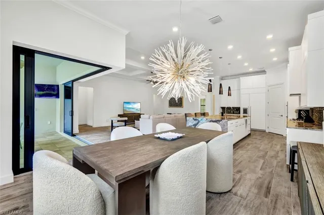 a living room with furniture kitchen view and a large window