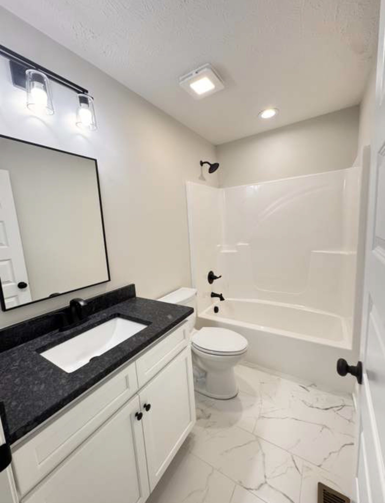 2105 Maple Grove Road Cadiz, KY 42211 - Photo 11 of 13 a bathroom with a granite countertop sink a toilet a mirror and bathtub
