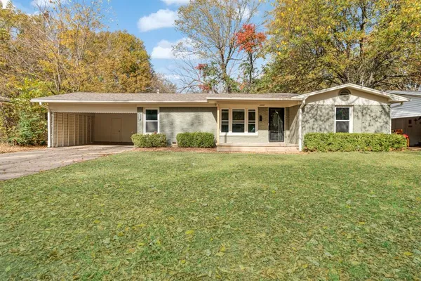 a front view of house with yard and green space
