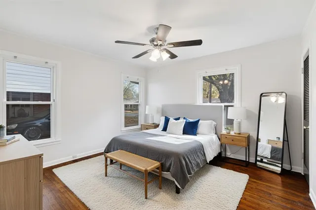 a bedroom with a bed wooden floor and a window