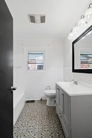 a bathroom with a sink toilet and vanity
