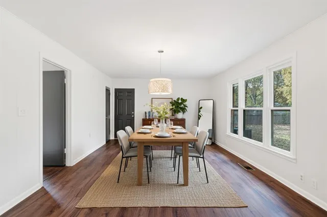 a view of a dining room with furniture window and wooden floor