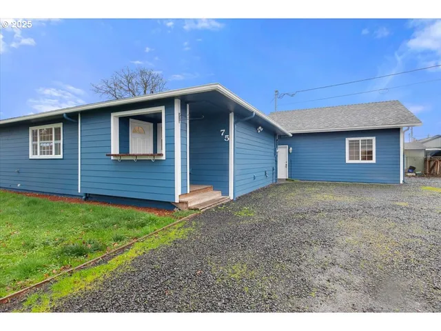 a backyard of a house with a yard and garage
