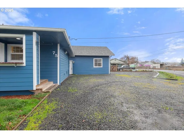 a backyard of a house with lots of green space and outdoor seating