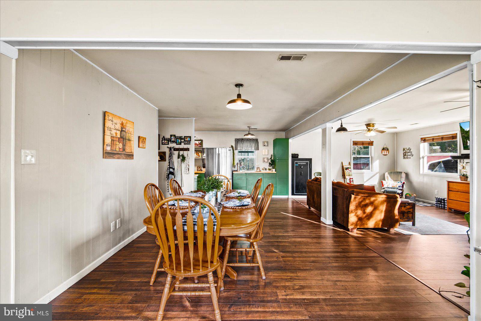 23165 Fork Bridge Road Milford, VA 22514 - Photo 50 of 51 a dining room with furniture wooden floor and a rug