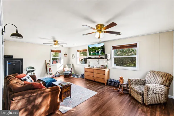 a living room with furniture and wooden floor
