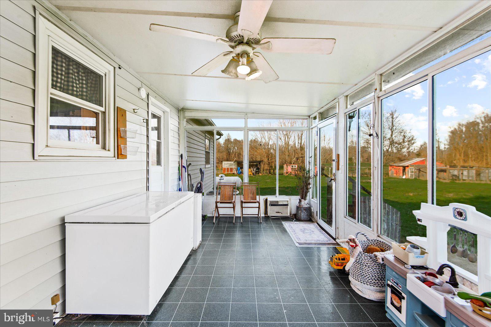 23165 Fork Bridge Road Milford, VA 22514 - Photo 27 of 51 a living room with furniture and a floor to ceiling window