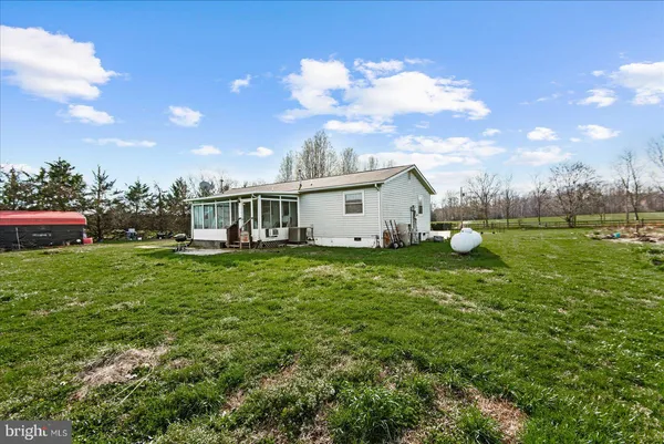 a view of a house with a backyard and a garden
