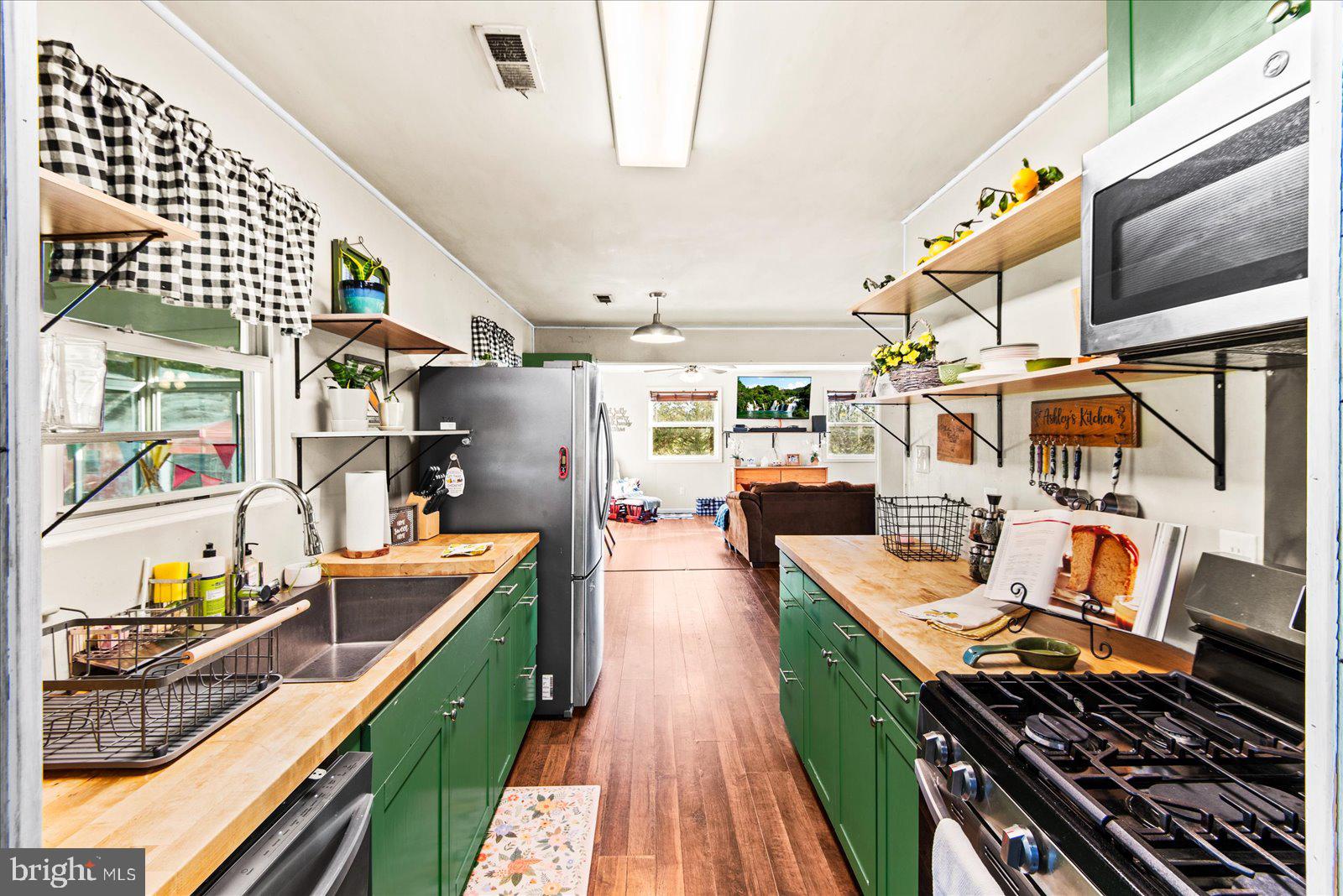 23165 Fork Bridge Road Milford, VA 22514 - Photo 4 of 51 a kitchen with stainless steel appliances granite countertop a stove and cabinets