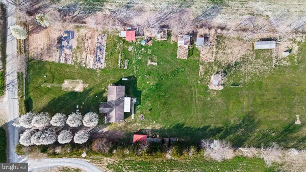 an aerial view of a house with a garden and lake view