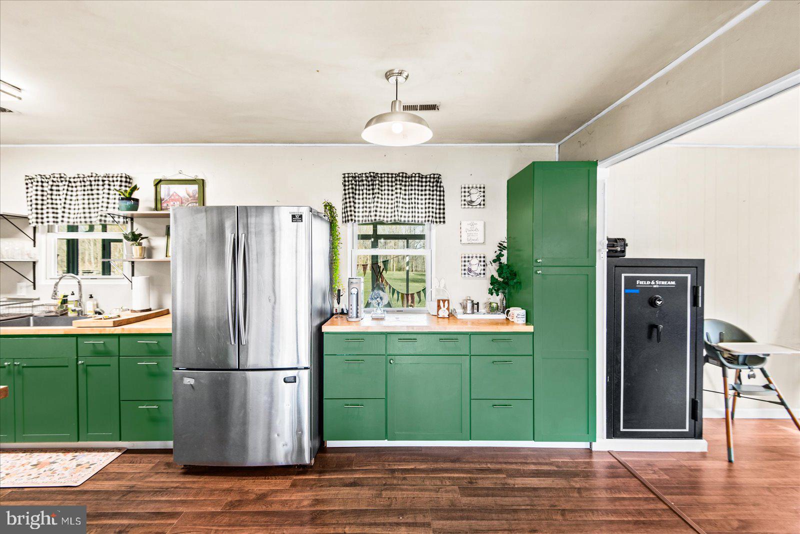 23165 Fork Bridge Road Milford, VA 22514 - Photo 5 of 51 a kitchen with kitchen island a refrigerator and a cabinets