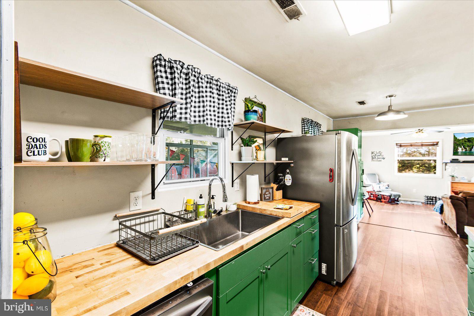 23165 Fork Bridge Road Milford, VA 22514 - Photo 7 of 51 a kitchen with stainless steel appliances kitchen island granite countertop a refrigerator a stove and a wooden floors
