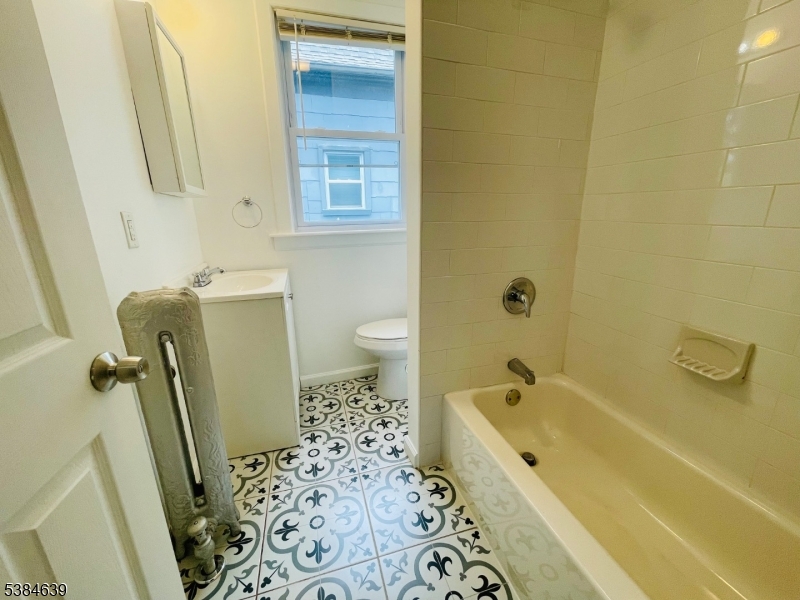 169 Hillside Avenue, Unit 2 Glen Ridge, NJ 07028 - Photo 8 of 10 a bathroom with a bathtub and a shower