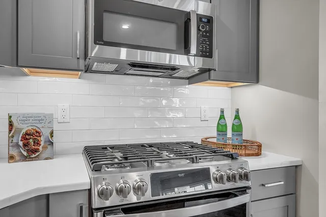 a stove top oven sitting inside of a kitchen