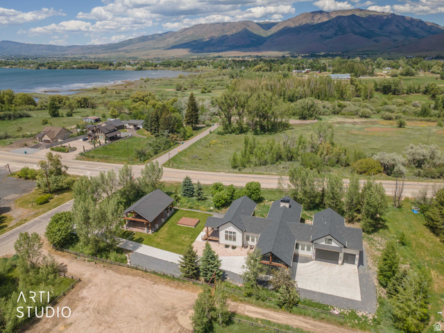 1188 South Old Trappers Loop Road Huntsville, UT 84317 - Photo 80 of 92 Modern multi-structure property featuring a main residence with an attached three-car garage, a separate barn-style outbuilding, and a gravel driveway
