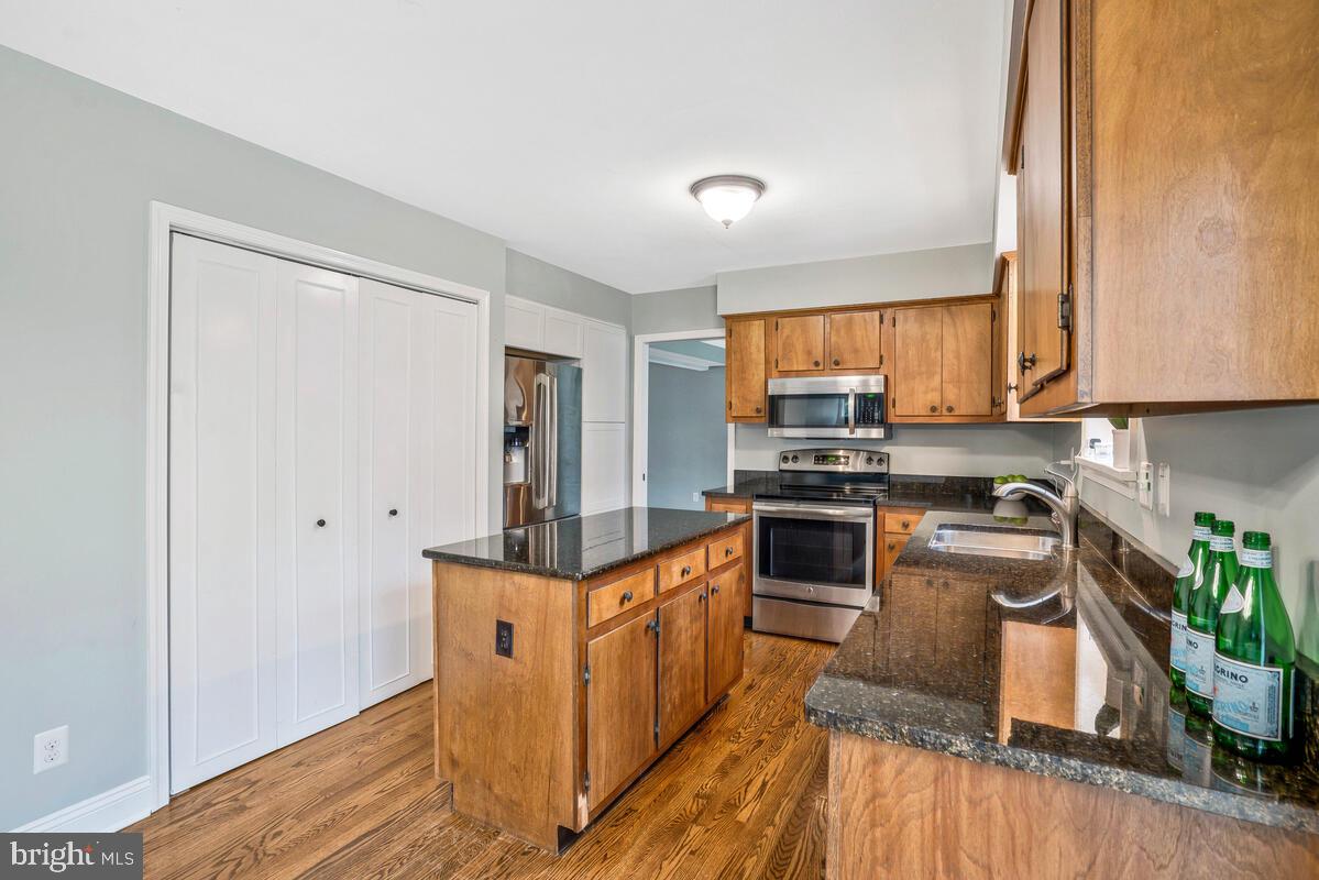 44576 Cedar Court California, MD 20619 - Photo 15 of 45 a kitchen with stainless steel appliances granite countertop a stove a sink and a refrigerator