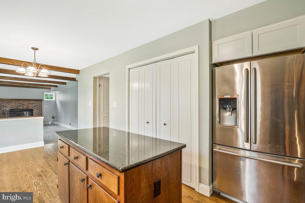 44576 Cedar Court California, MD 20619 - Photo 16 of 45 a kitchen with kitchen island a counter top space wooden floor and appliances