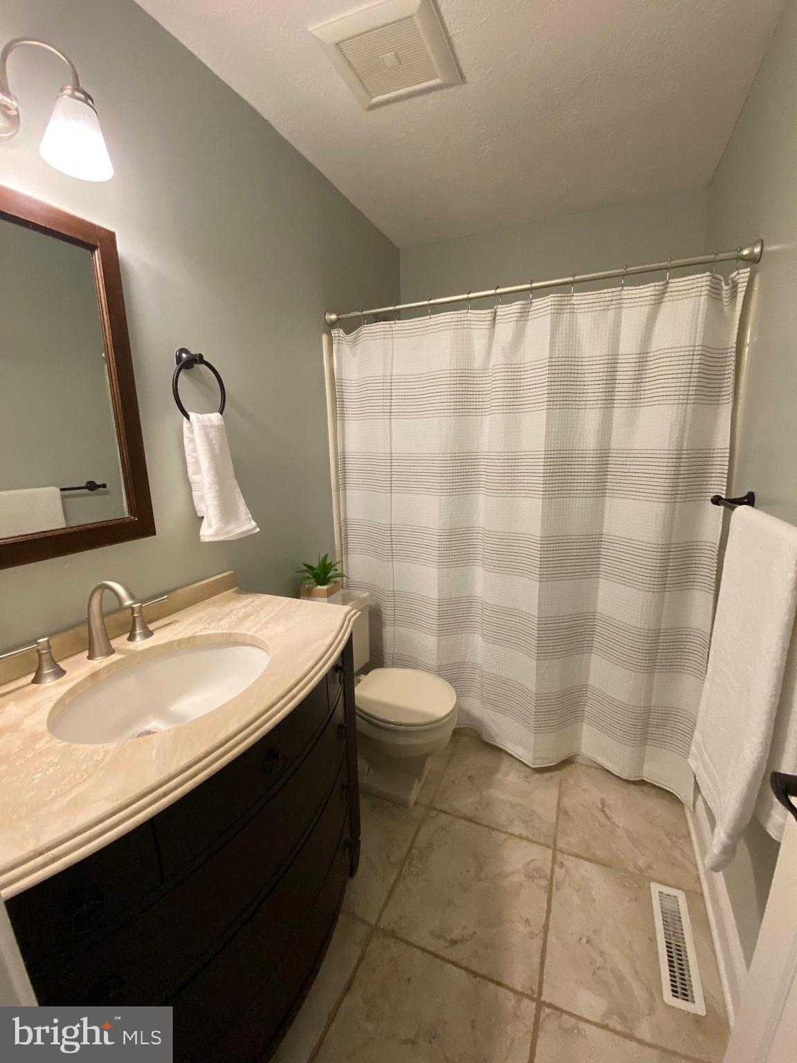 44576 Cedar Court California, MD 20619 - Photo 27 of 45 a bathroom with a sink a toilet and shower