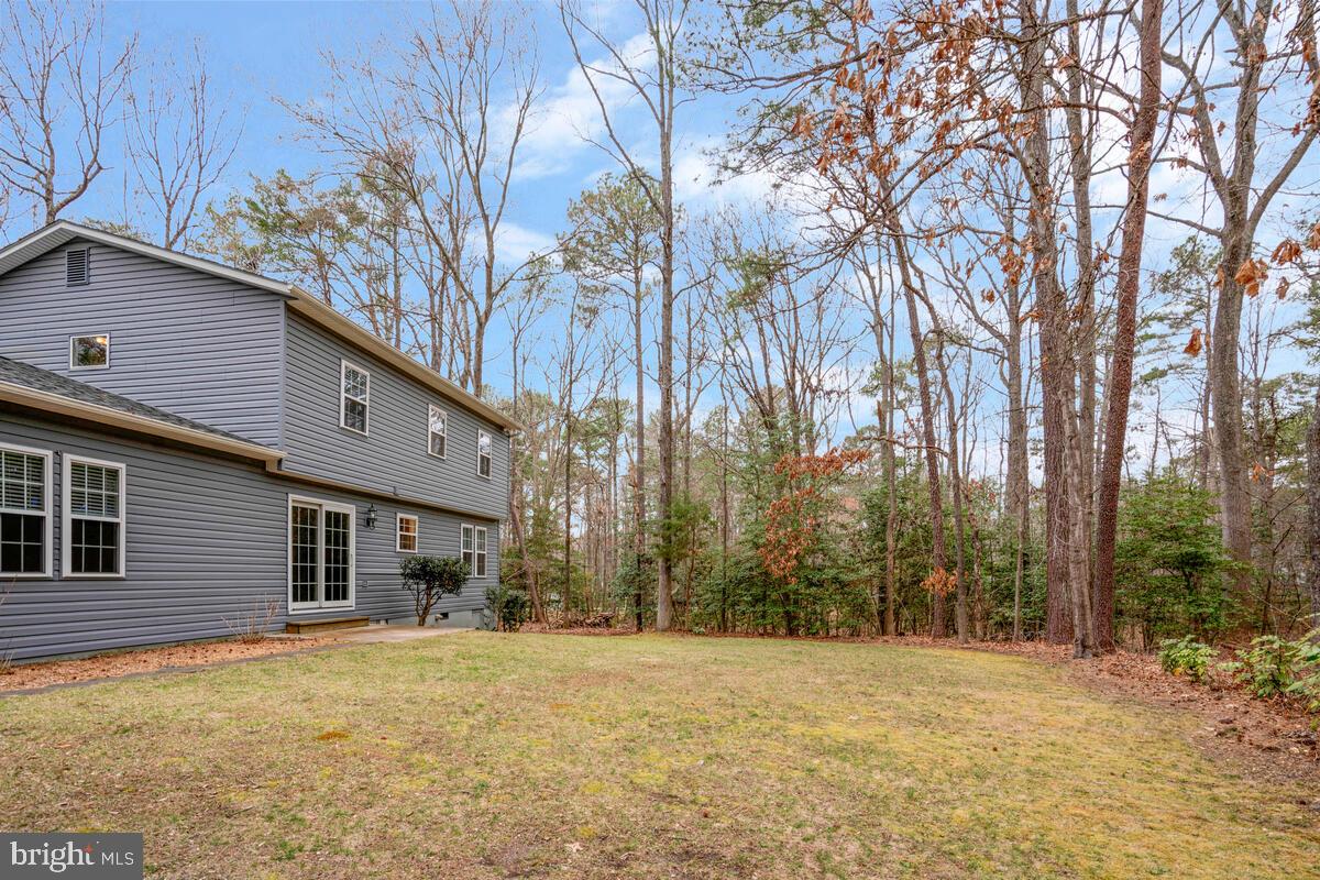 44576 Cedar Court California, MD 20619 - Photo 42 of 45 a front view of a house with a yard and trees