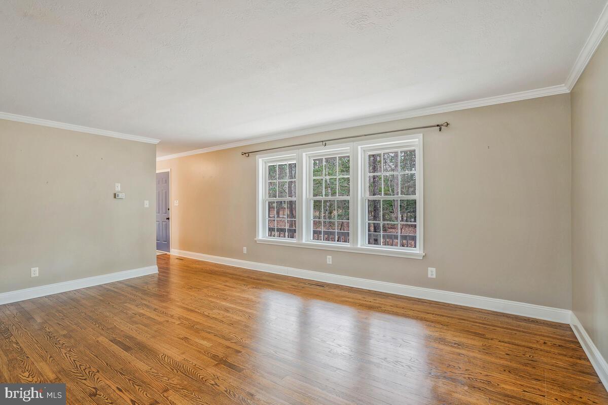 44576 Cedar Court California, MD 20619 - Photo 7 of 45 a view of an empty room with wooden floor and a window