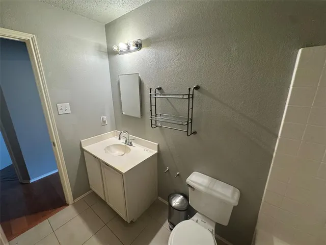 a bathroom with a toilet a sink and shower