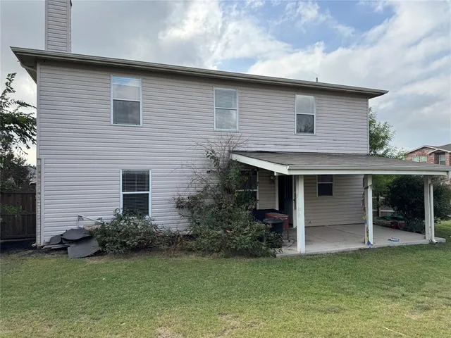 a view of a yard with a wooden fence