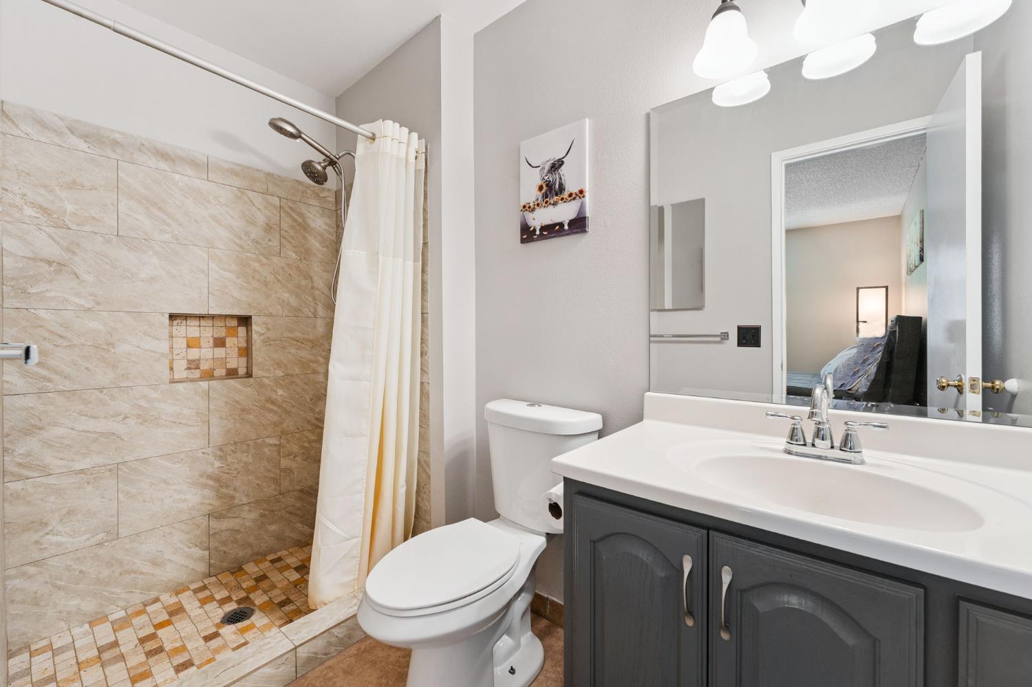 56 West Elliot Street, Unit 61 Woodland, CA 95695 - Photo 11 of 17 a bathroom with a sink toilet and shower