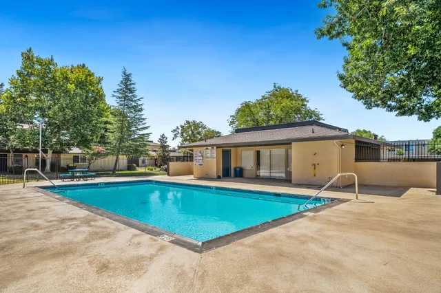 a swimming pool with outdoor seating and yard