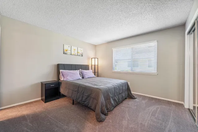 a spacious bedroom with a bed and window