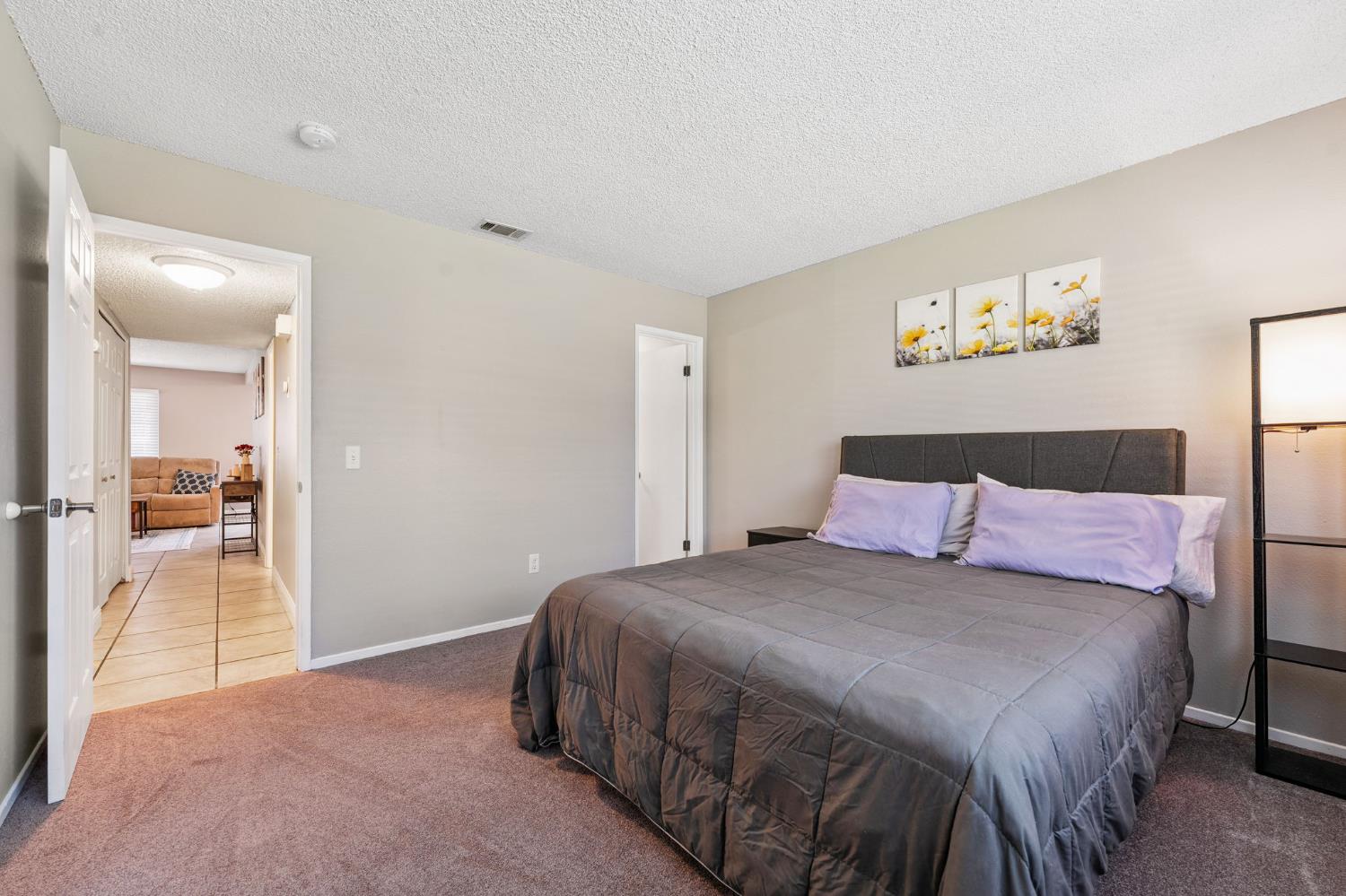 56 West Elliot Street, Unit 61 Woodland, CA 95695 - Photo 10 of 17 a bedroom with a bed and a chandelier