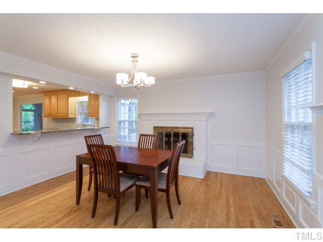 7312 Wilderness Road Raleigh, NC 27613 - Photo 11 of 23 a view of a dining room with furniture and wooden floor