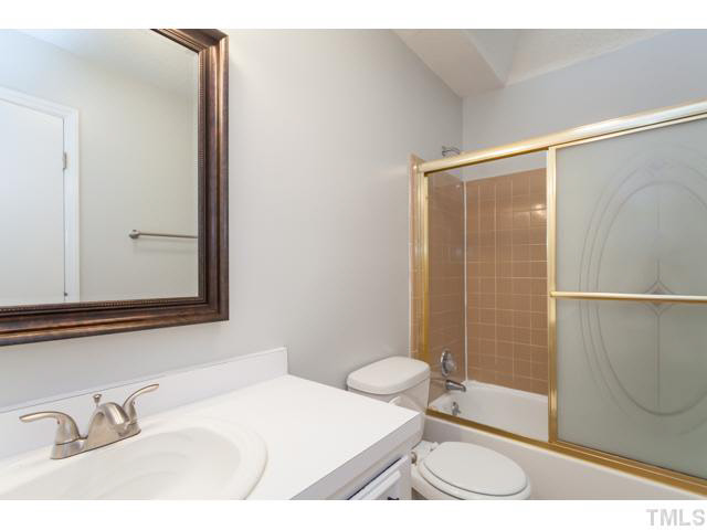 7312 Wilderness Road Raleigh, NC 27613 - Photo 16 of 23 a bathroom with a sink and a mirror