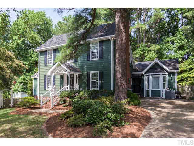 7312 Wilderness Road Raleigh, NC 27613 - Photo 2 of 23 a front view of a house with a yard