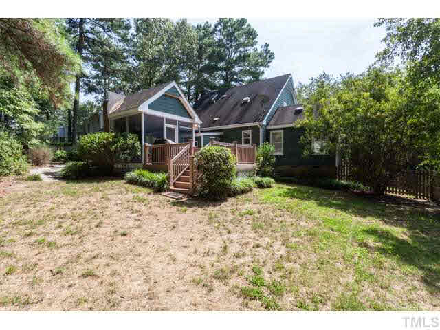 7312 Wilderness Road Raleigh, NC 27613 - Photo 21 of 23 a front view of a house with a garden