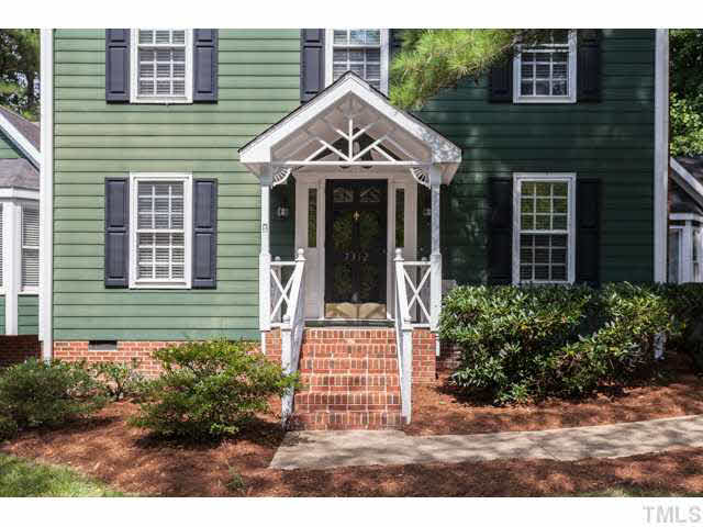 7312 Wilderness Road Raleigh, NC 27613 - Photo 3 of 23 a front view of a house with a garden