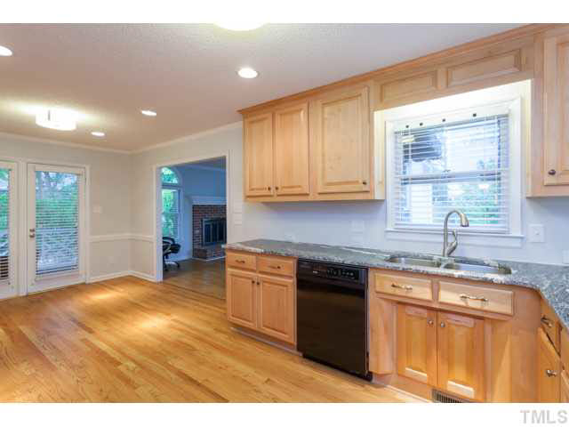7312 Wilderness Road Raleigh, NC 27613 - Photo 8 of 23 a kitchen with stainless steel appliances granite countertop a sink stove and cabinets