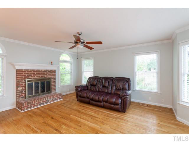 7312 Wilderness Road Raleigh, NC 27613 - Photo 9 of 23 a living room with furniture and a fireplace
