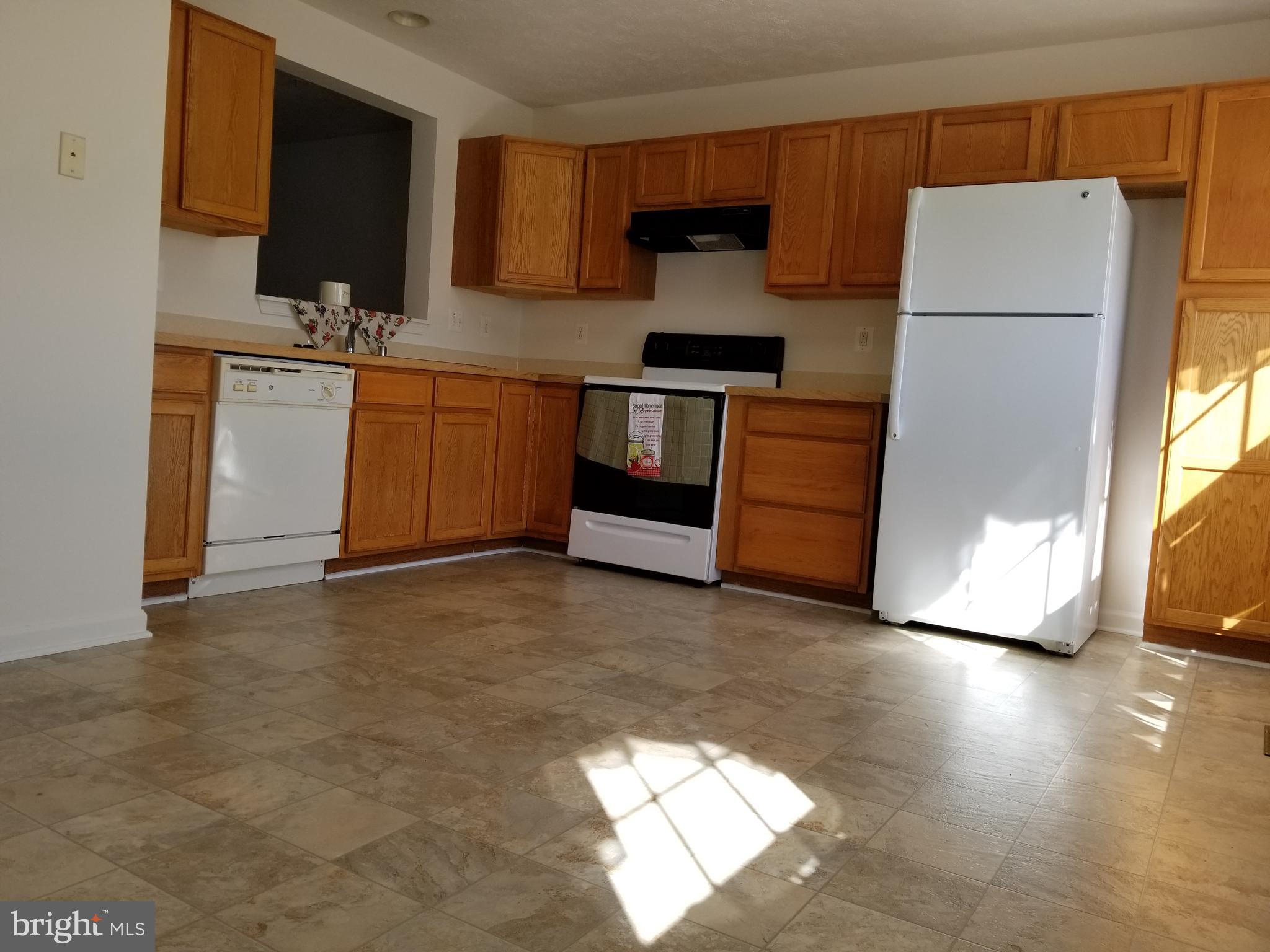 9736 Selfridge Road Baltimore, MD 21220 - Photo 2 of 35 a kitchen with stainless steel appliances a refrigerator and a stove top oven