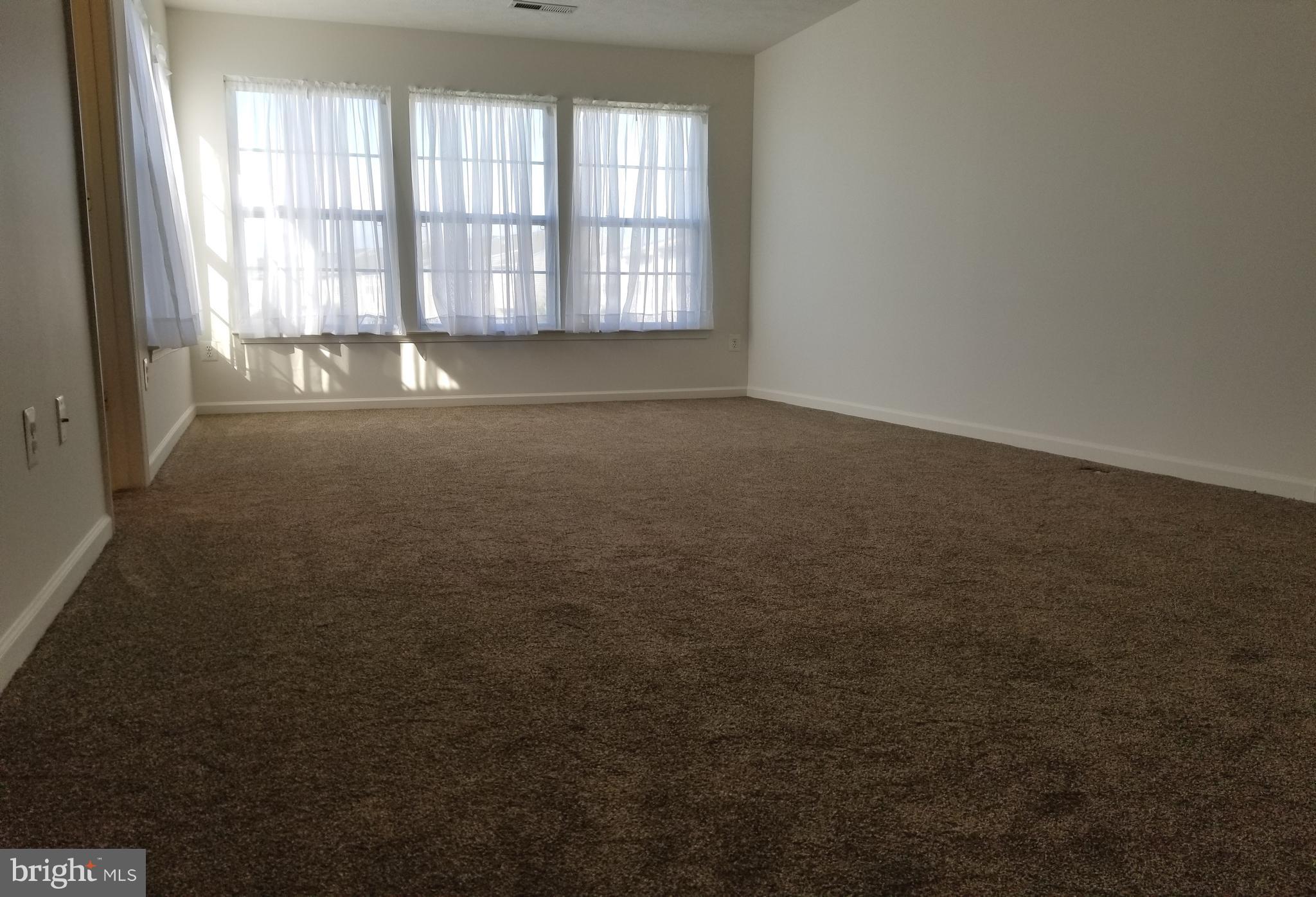 9736 Selfridge Road Baltimore, MD 21220 - Photo 19 of 35 an empty room with a empty space and windows