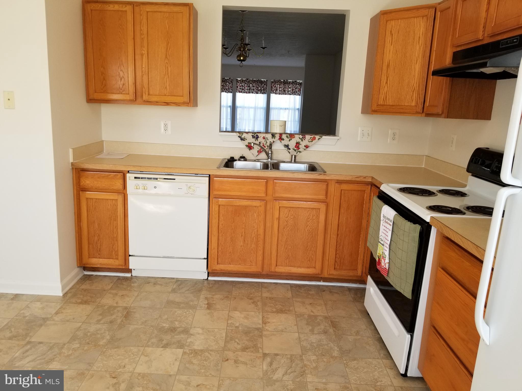 9736 Selfridge Road Baltimore, MD 21220 - Photo 3 of 35 a kitchen with granite countertop a sink stove and cabinets