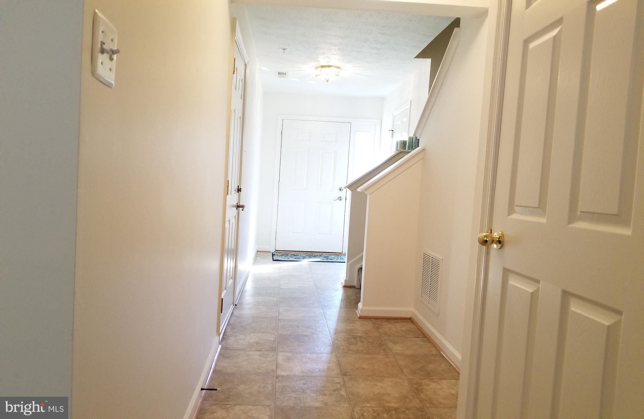 9736 Selfridge Road Baltimore, MD 21220 - Photo 29 of 35 a view of a hallway with a door and stairs