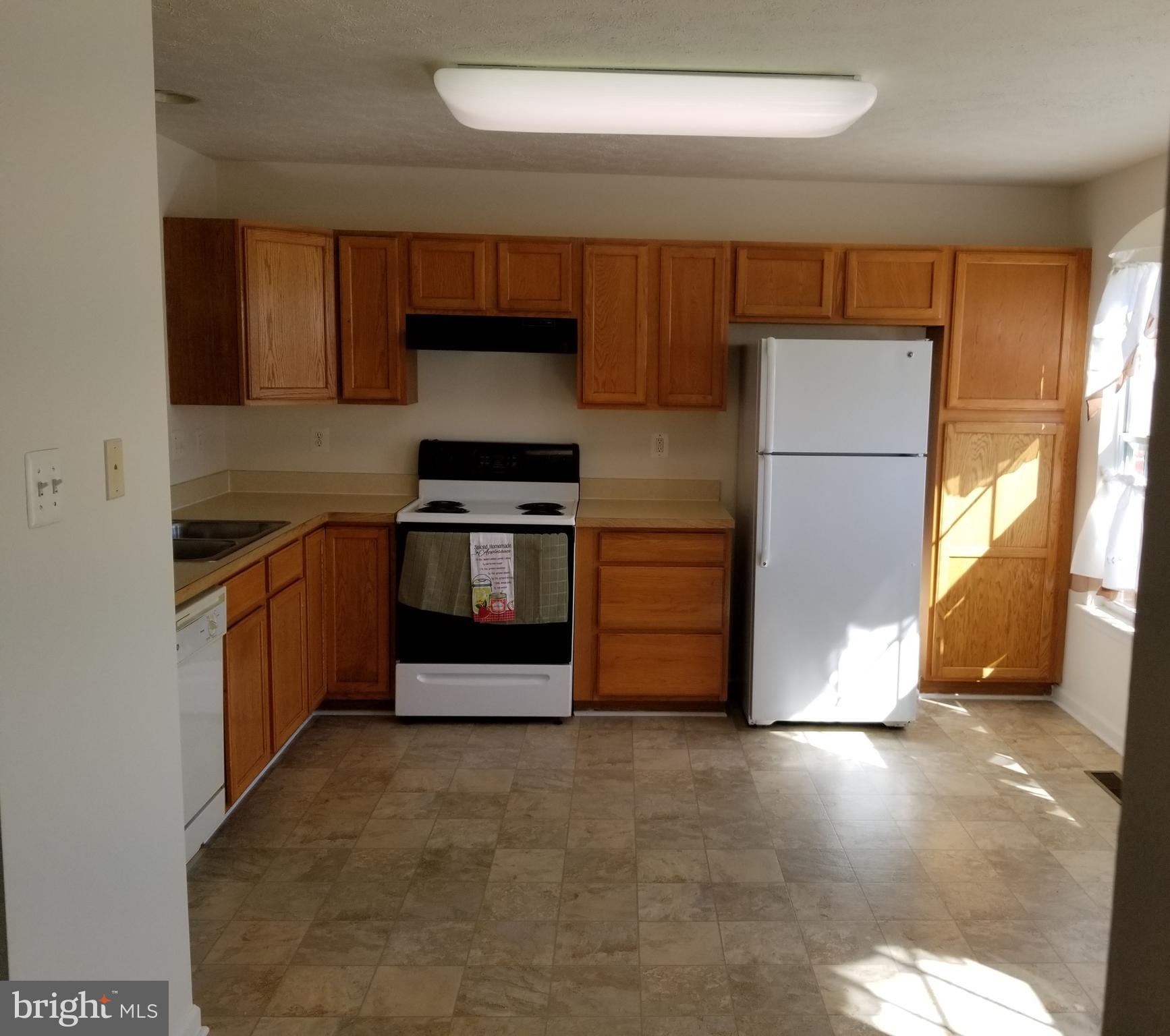9736 Selfridge Road Baltimore, MD 21220 - Photo 4 of 35 a kitchen with stainless steel appliances granite countertop a stove a refrigerator and a sink