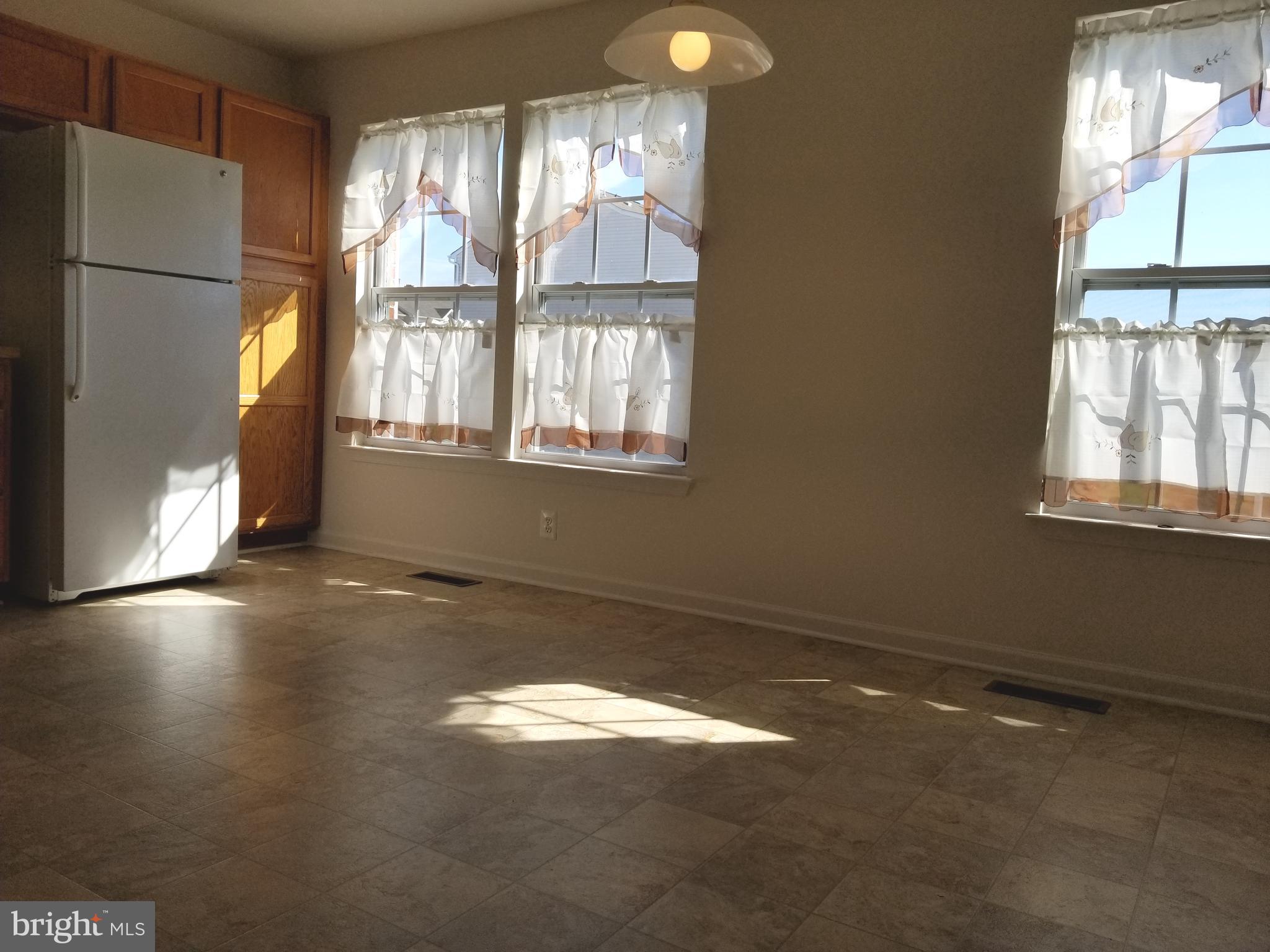 9736 Selfridge Road Baltimore, MD 21220 - Photo 7 of 35 a view of empty room with wooden floor and fan