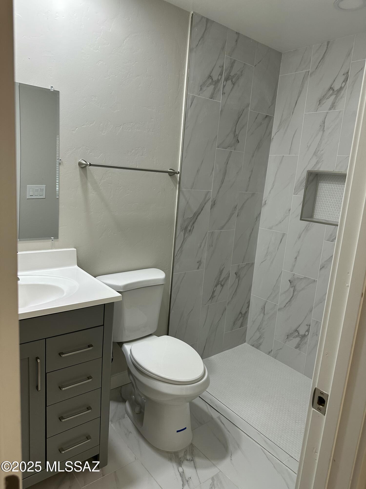645 East Mabel Street Tucson, AZ 85705 - Photo 11 of 22 a bathroom with a toilet and a shower