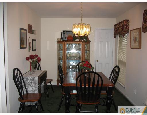 0 Timber Oaks Road Edison, NJ 08820 - Photo 3 of 10 a view of a dining room with furniture and chandelier
