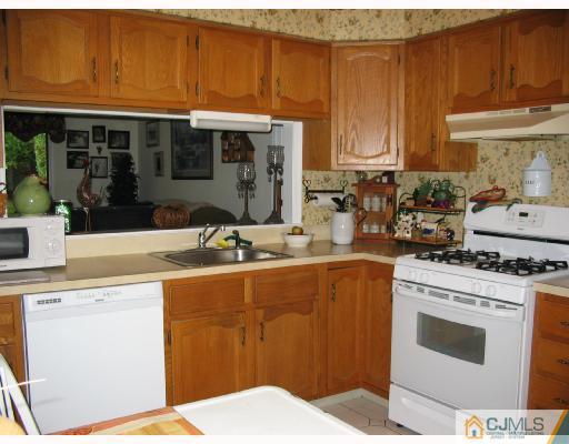 0 Timber Oaks Road Edison, NJ 08820 - Photo 5 of 10 a kitchen with stainless steel appliances granite countertop a stove a sink and a microwave