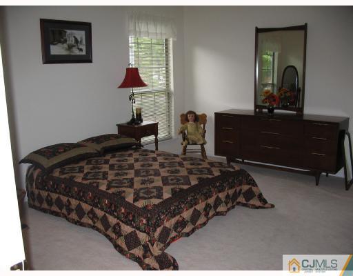0 Timber Oaks Road Edison, NJ 08820 - Photo 7 of 10 a bedroom with a bed and a dresser