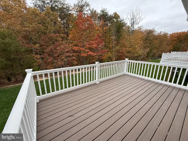 a view of a house with wooden deck