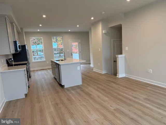 a kitchen with a refrigerator a sink and cabinets