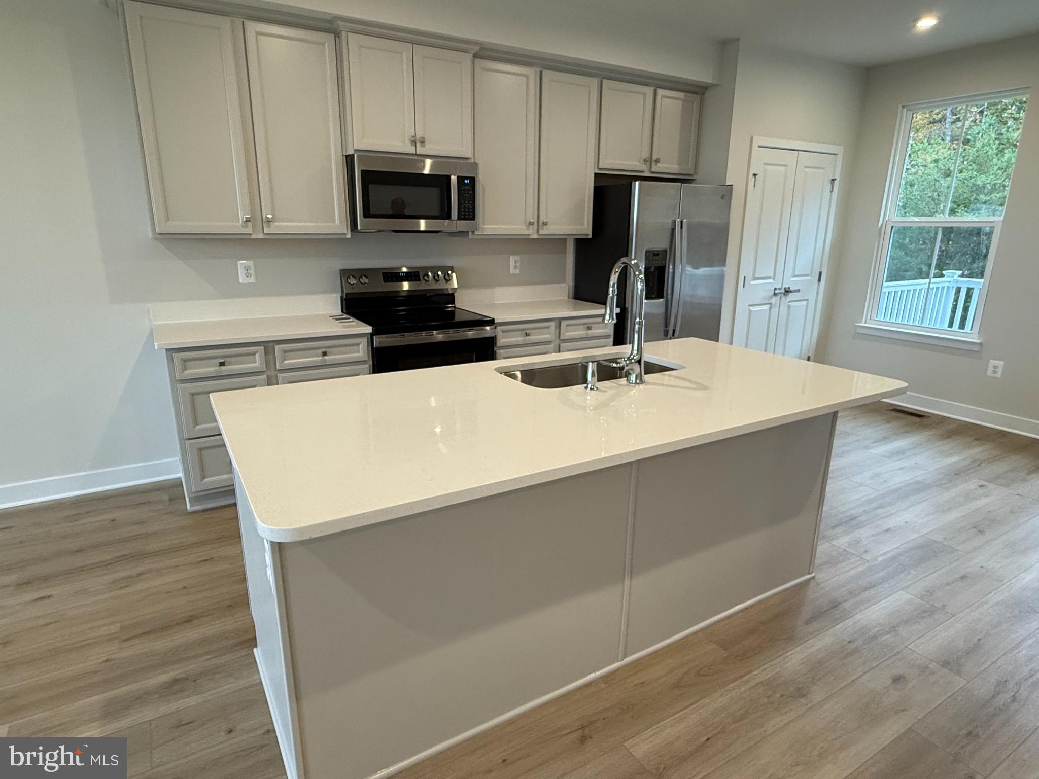 6932 Braxton Springs Way Spotsylvania, VA 22553 - Photo 9 of 33 a kitchen with stainless steel appliances a refrigerator sink stove and microwave
